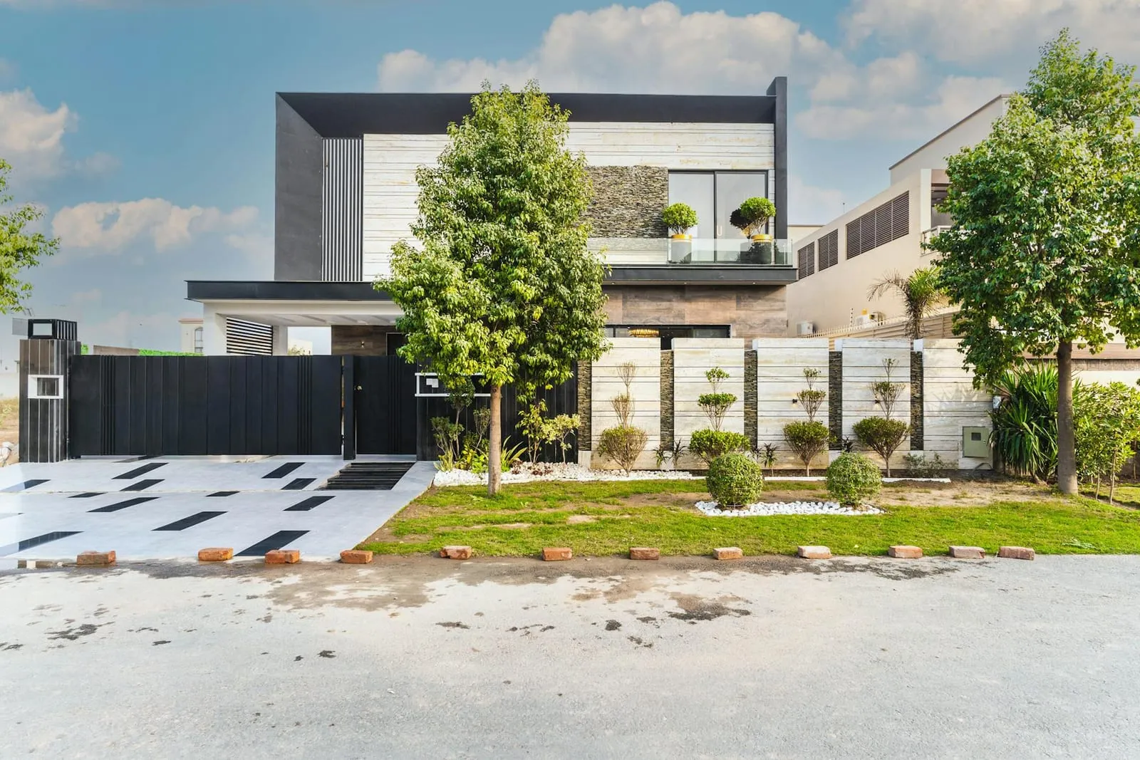 Contemporary villa with a stone facade and a landscaped front garden